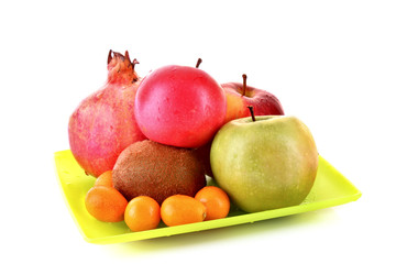 Pomergranate, kiwi, few apple and kumquat isolated on white