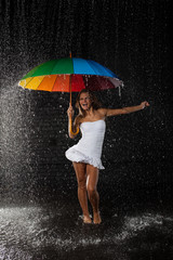 .Young woman with multi-coloured umbrella.