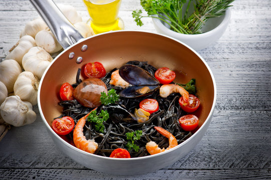 casserole with pasta tagliolini ink squid-tagliolini nero seppia