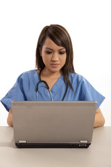 Filipino nurse doctor working on laptop