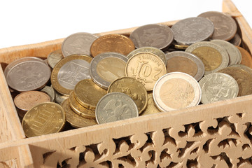 Carved wooden box filled with coins