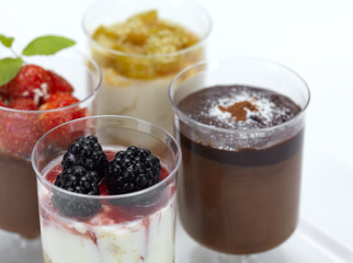 a close up of four desserts