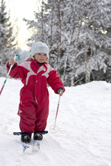 Happy toddler (2) skiing for the first time