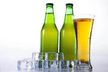Bottle of beer with water-drop on white background
