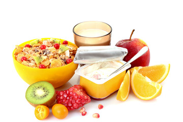 Yoghurt, muesli, milk and fruits isolated on white