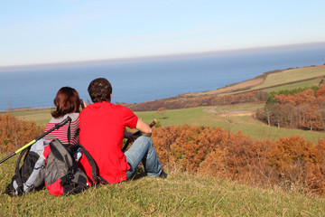 Naklejka na ściany i meble Couple hiking in countryside on beautiful fall day
