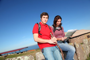 Couple hiking in countryside looking at map