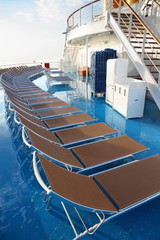 row of chaise longues on deck of cruise ship.