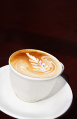 Coffee cup with milk and flower shape