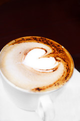 Coffee cup with milk and heart shape