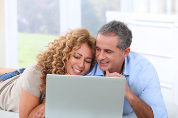 Couple surfing on internet at home