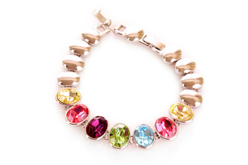 silver and diamonds bracelet with color  stones on white backgro