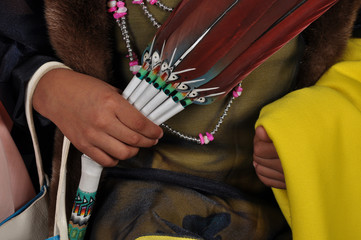 Native american child holding feathers