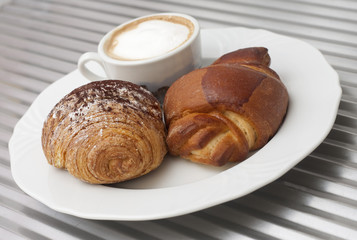 Italian breakfast, cappuccino and croissant