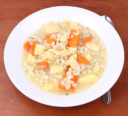 Barley soup on a wooden background
