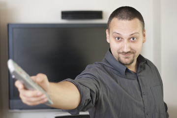 man holding  television  remote controller