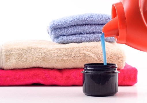 Laundry Detergent Pouring Into Measuring Cap