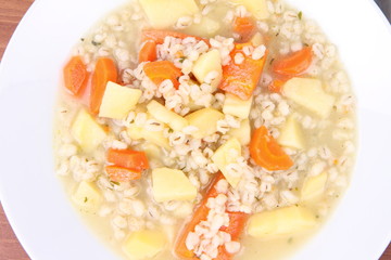 Barley soup on a wooden background
