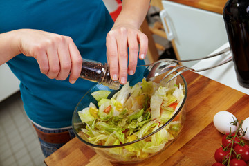 Woman seasoning with pepper