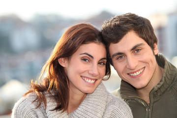 Portrait of young smiling couple in town