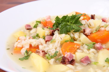 Barley soup on a wooden background