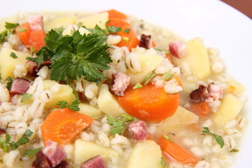 Barley soup on a wooden background