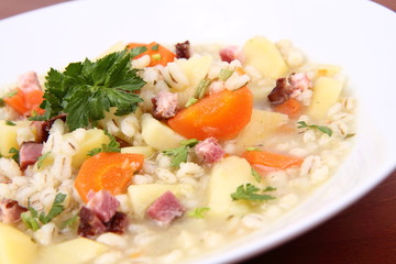 Barley soup on a wooden background