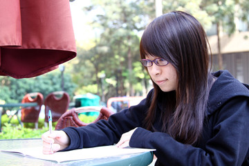 Chinese girl reading book in a University
