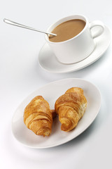 white coffee mug and croissants on plate