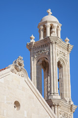 Fototapeta na wymiar High church bell tower opposite blue sky