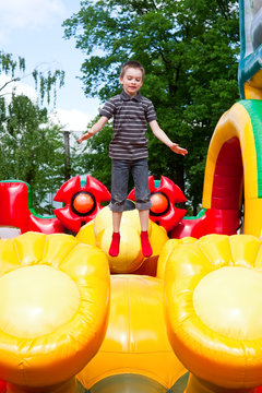 Boy In Inflatable Playground