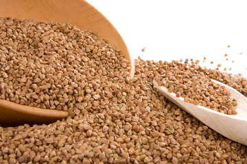 buckwheat and wood spoon isolated on white
