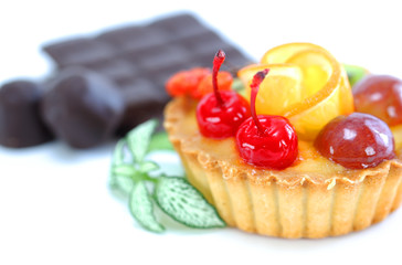 Cupcake with jelly and fruits over white