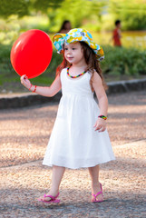 The little girl with balloon in park