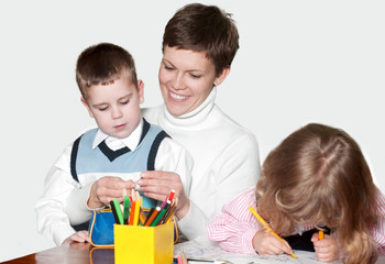 Mother and children together paint an album and have fun togethe