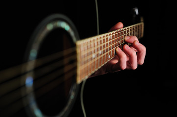 Man's hand striking a chord