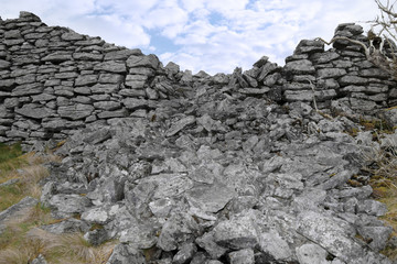 broken high stone wall