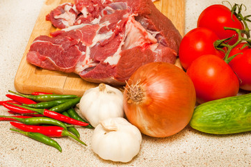 Fresh lamb meat and vegetables on a kitchen counter