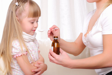 Little girl drinking cough syrup
