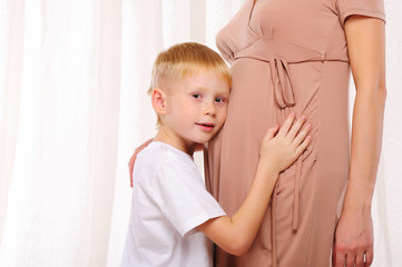 little boy and his pregnant mother