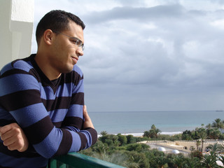Tunisian man watching the ocean