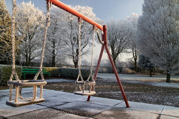 Fototapeta na wymiar Frozen swing in the park