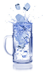 Ice cubes throwing into glass