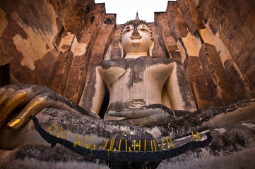 buddha staue in the temple ruins of sukhothai in thailand . .