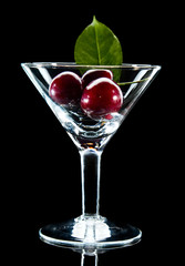 Glass with ripe sweet cherry