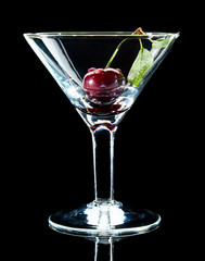 Sweet cherry with leaf in glass