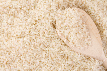 rice background and wood spoon