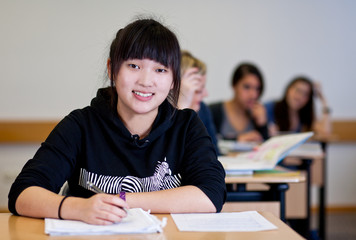 Student working on homework in classroom