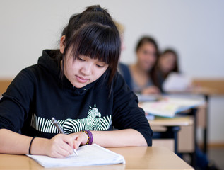 Student working on homework in classroom