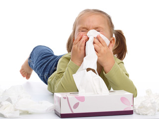Little girl blows her nose